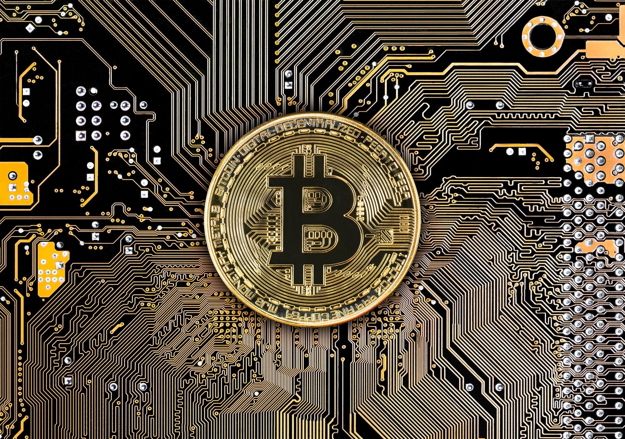 Bitcoin coins on black circuit board